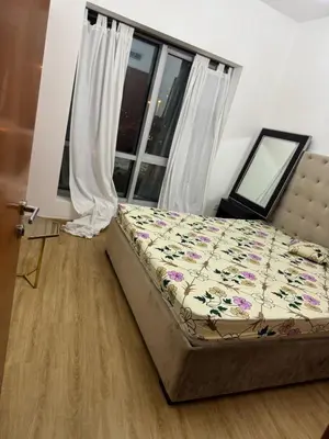 a bedroom with a bed and a window at Supper holly days home in Dubai