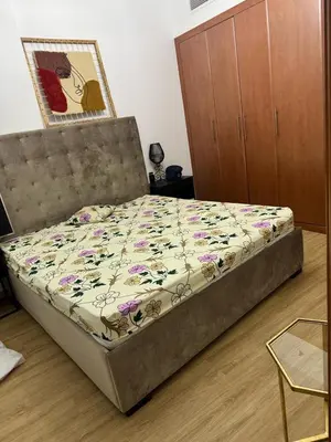 a bed in a bedroom with a bed frame at Supper holly days home in Dubai