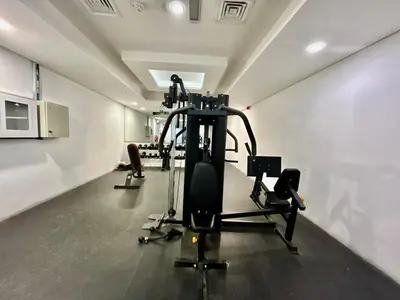 a gym with several tread machines in a room at Homes2Retreat - Serene 1BR Getaway with Stunning Views in Dubai