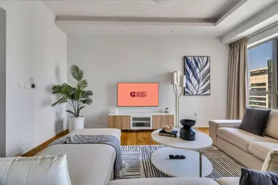 a living room with a couch and a tv at GuestReady - Chic High-Rise with Canal Views in Dubai