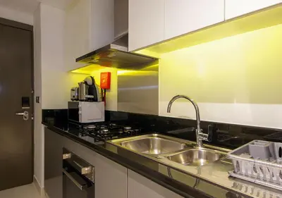 a kitchen with a sink and a stove at Stunning Pool View DAMAC Prive, Business Bay in Dubai