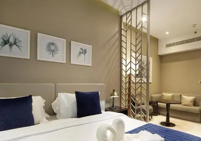 a bedroom with a bed and a living room at Stunning Pool View DAMAC Prive, Business Bay in Dubai