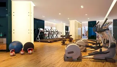 a gym with many exercise equipment in a room at Stunning Pool View DAMAC Prive, Business Bay in Dubai