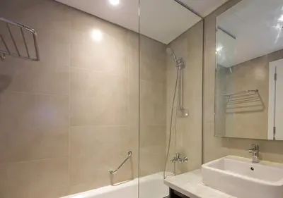 a bathroom with a shower and a sink at Stunning Pool View DAMAC Prive, Business Bay in Dubai