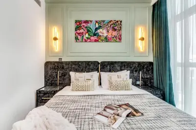 a bedroom with a large bed with a blanket and pillows at The Smart Concierge - Urban Oasis by Missoni in Dubai