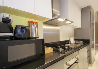 a kitchen with a stove and a microwave at Elegant Studio with Canal Views DAMAC Prive in Dubai