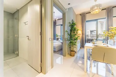 a dining room with a table and chairs and windows at City Views 1BR with Balcony Near Dubai Water Canal, Zada Tower, Business Bay by Deluxe Holiday Homes in Dubai