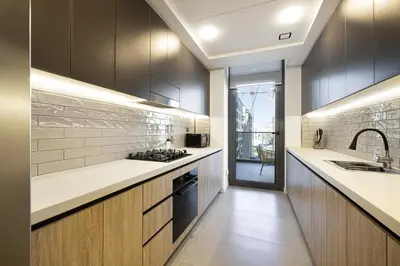 a kitchen with a sink and a stove top oven at Daniels 2BR at Jumeirah Garden City in Dubai