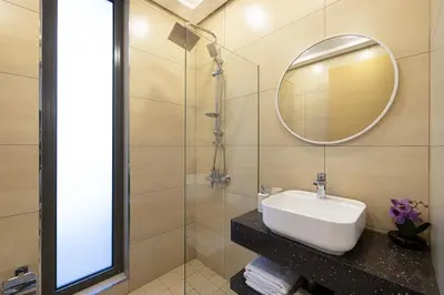 a bathroom with a sink and a mirror at Daniels 2BR at Jumeirah Garden City in Dubai