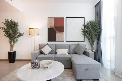 a living room with a couch and a table at Mahogany 6 - 2BR 8PAX - Infinity Pool & High-floor in Dubai