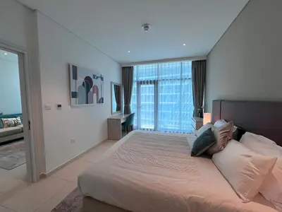 a bedroom with a large bed with a large window at Stunning 1 bedroom apartment in Seven Palm Dubai in Dubai
