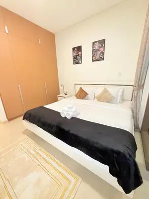 a bedroom with a large bed with a black blanket at 1 Bed With Private Beach Access In Dubai Creek Harbour in Dubai
