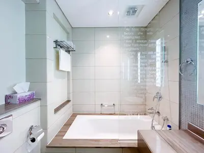 a bathroom with a shower and a bath tub at 2BR Apartment in Paramount Tower in Dubai