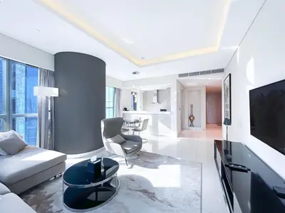 a living room with a couch and a tv at 2BR Apartment in Paramount Tower in Dubai