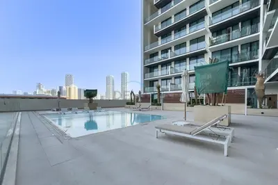 a swimming pool on the roof of a building at Skyline and Community Views 1BR with Private Balcony Near Community Park, Binghatti Amber, Jumeirah Village Circle by Deluxe Holiday Homes in Dubai