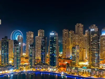a night view of a large city with lights at Vida Yacht Club # Up-scale 2BHK # Marina,Sea & Ain View in Dubai