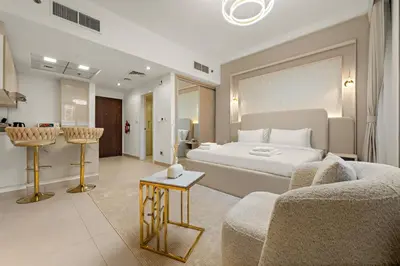a hotel room with a bed and a couch at Modern Compact Studio in JVC in Dubai