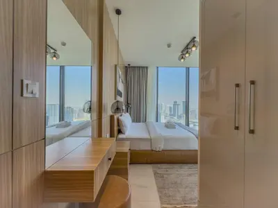 a bedroom with a bed and a large mirror at Elegant 2-BR with modern comfort in Dubai