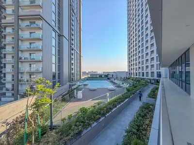 a building with a swimming pool in the middle of it at Elegant 2-BR with modern comfort in Dubai