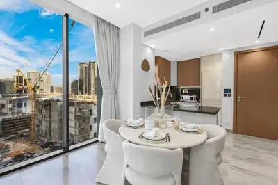 a dining room with a table and chairs and a large window at Luxury 1BR in Business Bay with Burj Khalifa Views, Balcony, Pool and Gym Access in Dubai