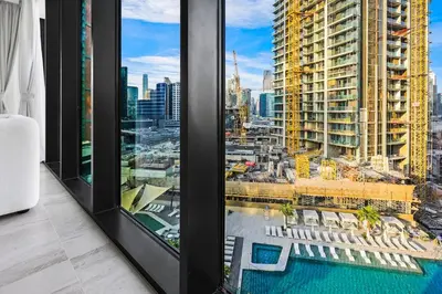 a room with a view of a city at Luxury 1BR in Business Bay with Burj Khalifa Views, Balcony, Pool and Gym Access in Dubai