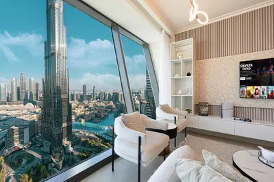a living room with a view of a skyscraper at 4BR Luxury Apartment with Burj Khalifa View and Direct Dubai Mall Access - Pool and PS5 Included in Dubai