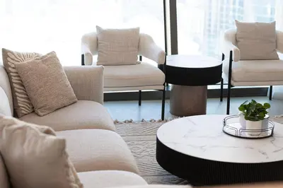 a living room with couches and a coffee table at 4BR Luxury Apartment with Burj Khalifa View and Direct Dubai Mall Access - Pool and PS5 Included in Dubai
