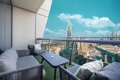 a balcony with couches and a view of a city at 4BR Luxury Apartment with Burj Khalifa View and Direct Dubai Mall Access - Pool and PS5 Included in Dubai