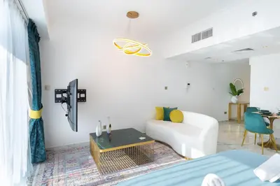 a living room with a white couch and a table at Chic City Retreat Steps from Dubai Mall & Dubai Opera in Dubai