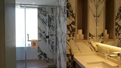 a bathroom with a shower and a sink at Cinematic View Studio - Emaar Residences in Dubai