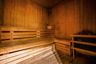an empty wooden sauna with a potted plant in it at Modern Studio with Balcony - Close to Metro & Marina in Dubai