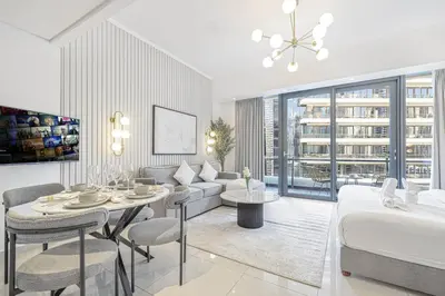a living room with a bed and a dining room at Luxury Studio in Dubai Marina with Canal views in Dubai