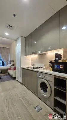 a kitchen with a washing machine in the middle at EGATE - Studio - 1st Floor with Terrace - Dubai - 31-109 in Dubai