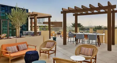 a patio with chairs and tables on a building at High-floor 1 Bedroom by Seven Apartments Palm Jumeirah in Dubai