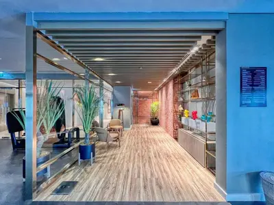 an office with a blue wall and a hallway at Stunning 1BR High Floor with Rooftop Infinity Pool in Dubai