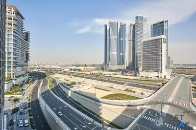 a highway in a city with tall buildings at Cozy Studio in Binghatti Canal - Close to Downtown in Dubai