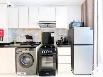a kitchen with a refrigerator and a washing machine at Serene Studio with Views in Al Waleed Garden 2 in Dubai