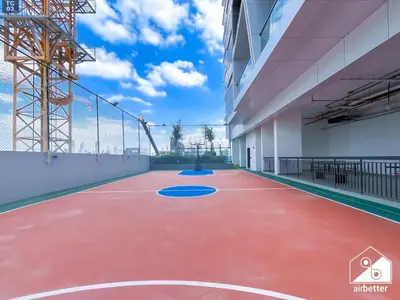 an empty basketball court in a building with a blue at Serene Studio with Views in Al Waleed Garden 2 in Dubai