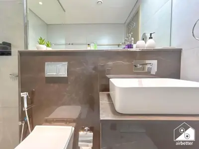a bathroom with a white sink and a mirror at Chic Comfort at oxford Residence in Dubai