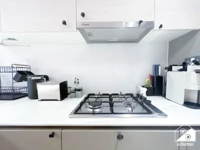 a kitchen with a stove top in a kitchen at Chic Comfort at oxford Residence in Dubai