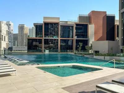 a large swimming pool in the middle of a building at Luxe 2BR Retreat, Canal Views & Prime Dubai Stay Near Attractions in Dubai