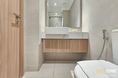 a bathroom with a sink and a toilet at Chic Modern Studio in Azizi Riviera in Dubai