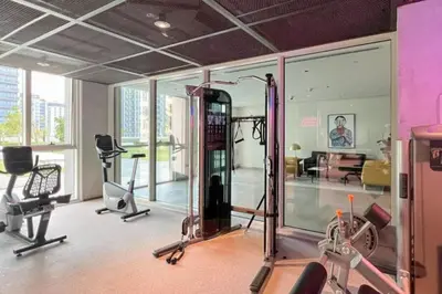 a gym with several exercise equipment in a room at Fresh & Stylish 2br Living At Collective Tower 1 in Dubai