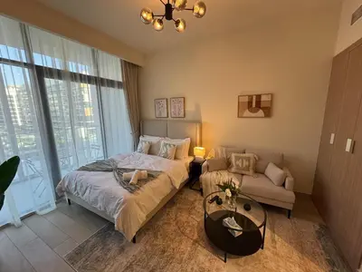 a bedroom with a bed and a couch at Amazing Studio for Rent in Dubai