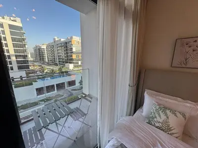 a bedroom with a window with a view of a city at Amazing Studio for Rent in Dubai