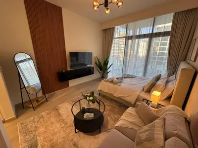a living room with a bed and a couch at Amazing Studio for Rent in Dubai