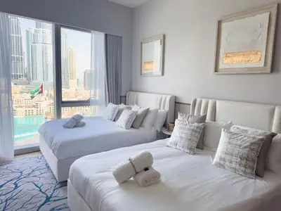 a hotel room with two beds and a large window at GRANDE SIGNATURE with a direct Burj Khalifa view and Private Fountain Show with DXB AIRPORT VIP Shuttle option for 8 guests in Dubai
