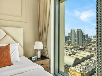a bedroom with a bed and a view of a city at Panoramic Burj Khalifa Views at Burj Royale by Propigo in Dubai