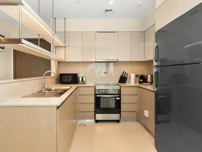 a kitchen with a stainless steel refrigerator and a sink at Panoramic Burj Khalifa Views at Burj Royale by Propigo in Dubai