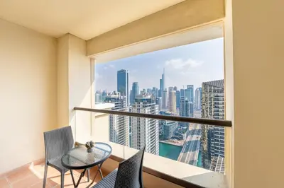 a balcony with a table and chairs and a view of the city at Luxe Marina View Retreat! 2BDRM in Dubai